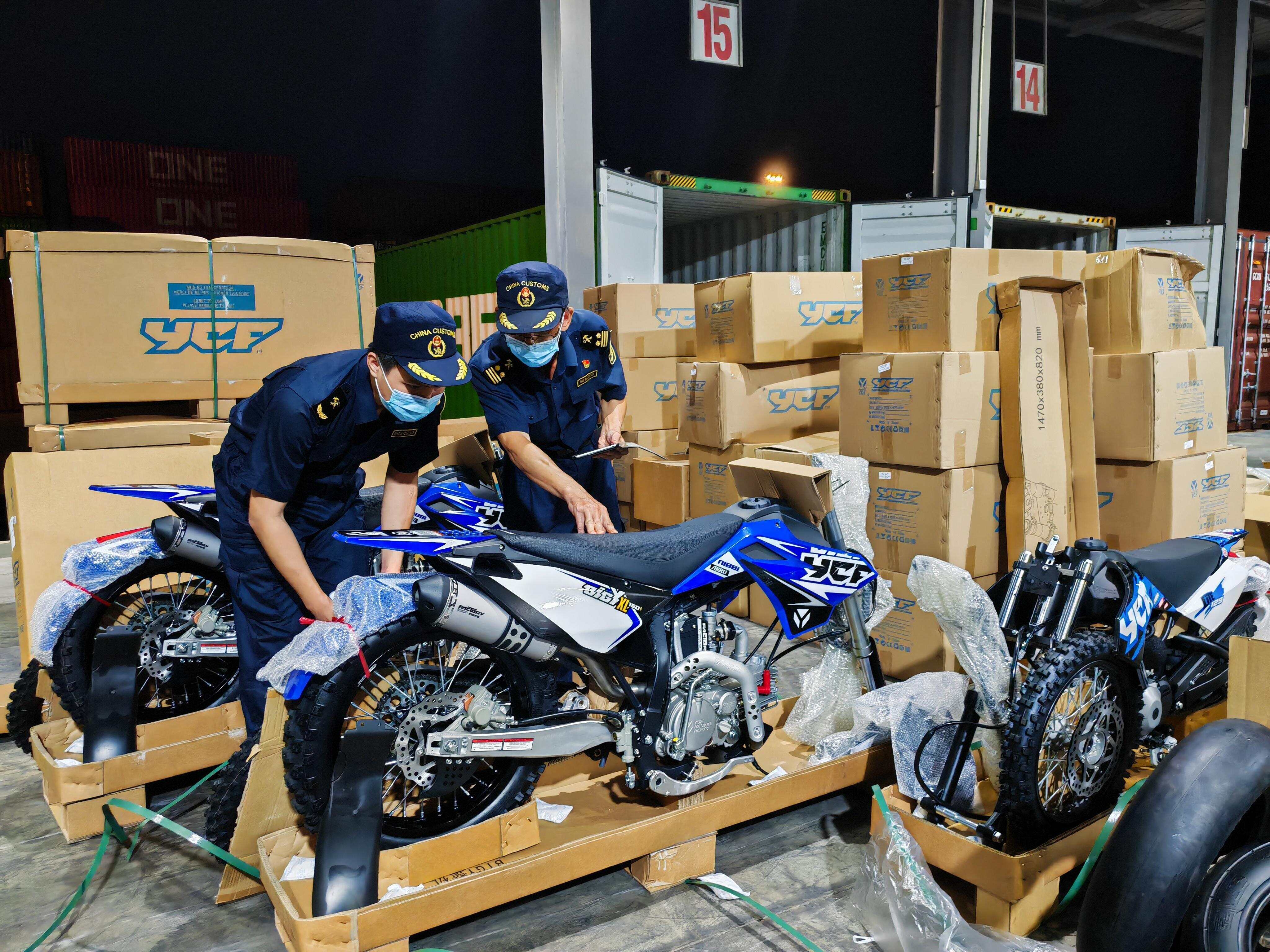 海关关员对出口非洲的江门摩托进行查验。张晶新 摄